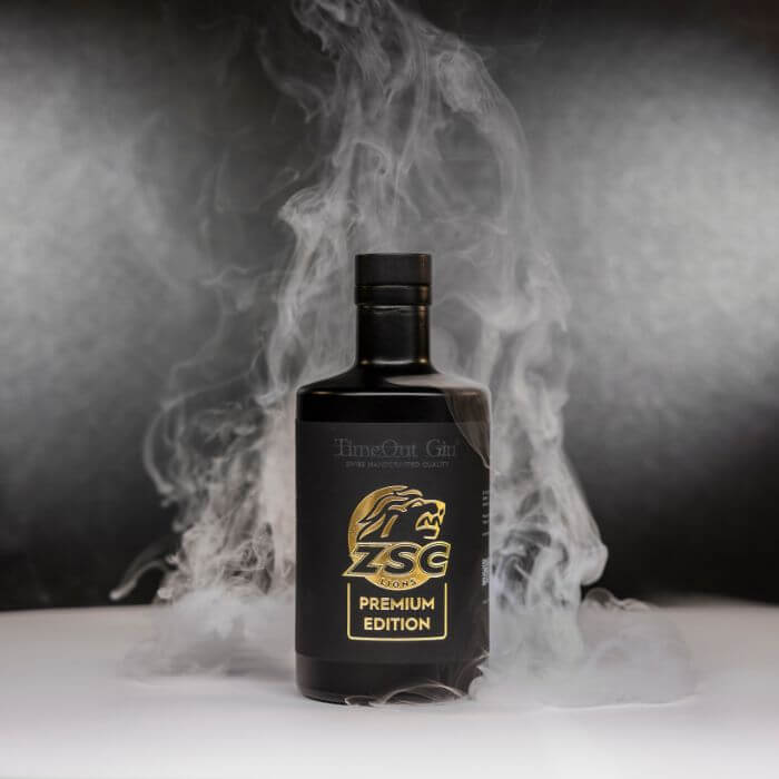 ZSC Premium Edition gin bottle with smoke backdrop, representing quality and enjoyment of Timeout Gin.