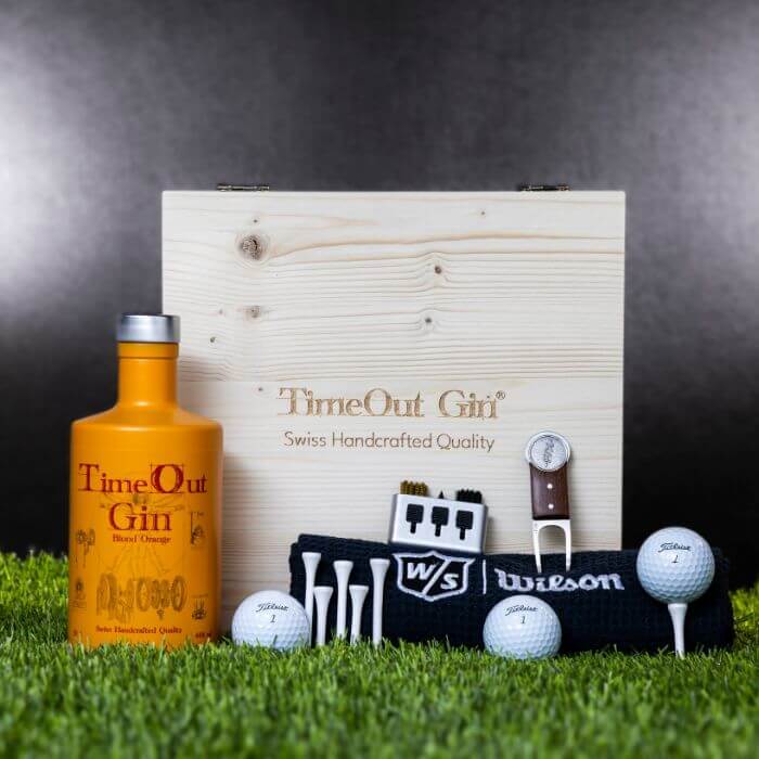 Exklusive TimeOut Gin Geschenkbox mit Golf-Accessoires auf grünem Rasen, ideal für Golfliebhaber.